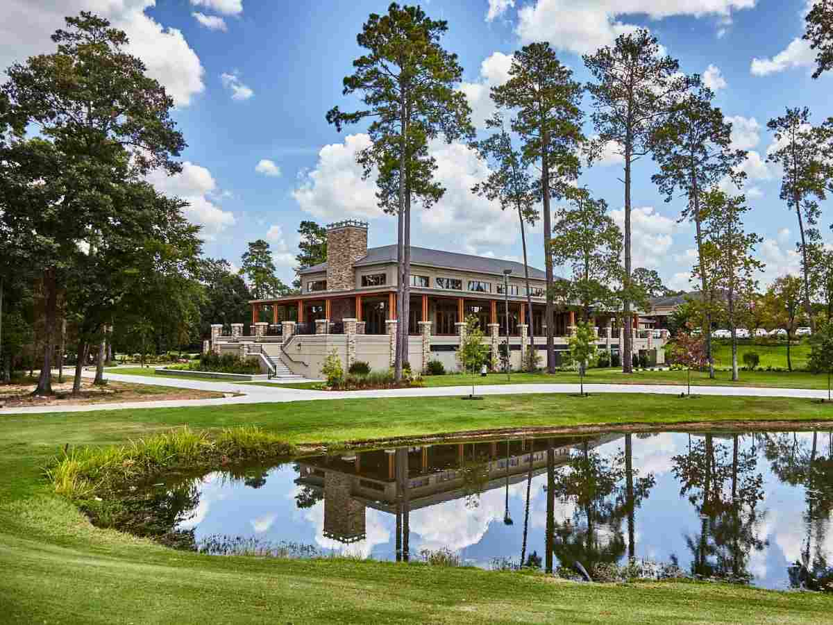 Woodlands Country Club view of clubhouse with lake.