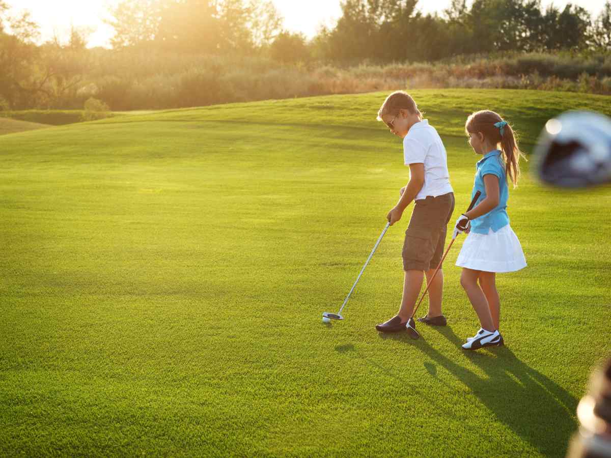 A young boy and girl playing golf for article Living in the Champion Forest Area: A Houston Gem for newcomers moving to Houston.