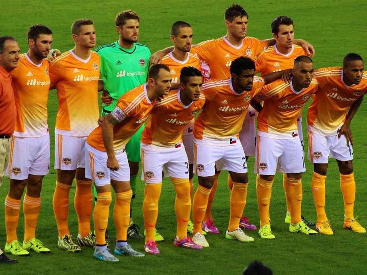 Soccer team posing for picture in 2 rows for article Houston Dynamo