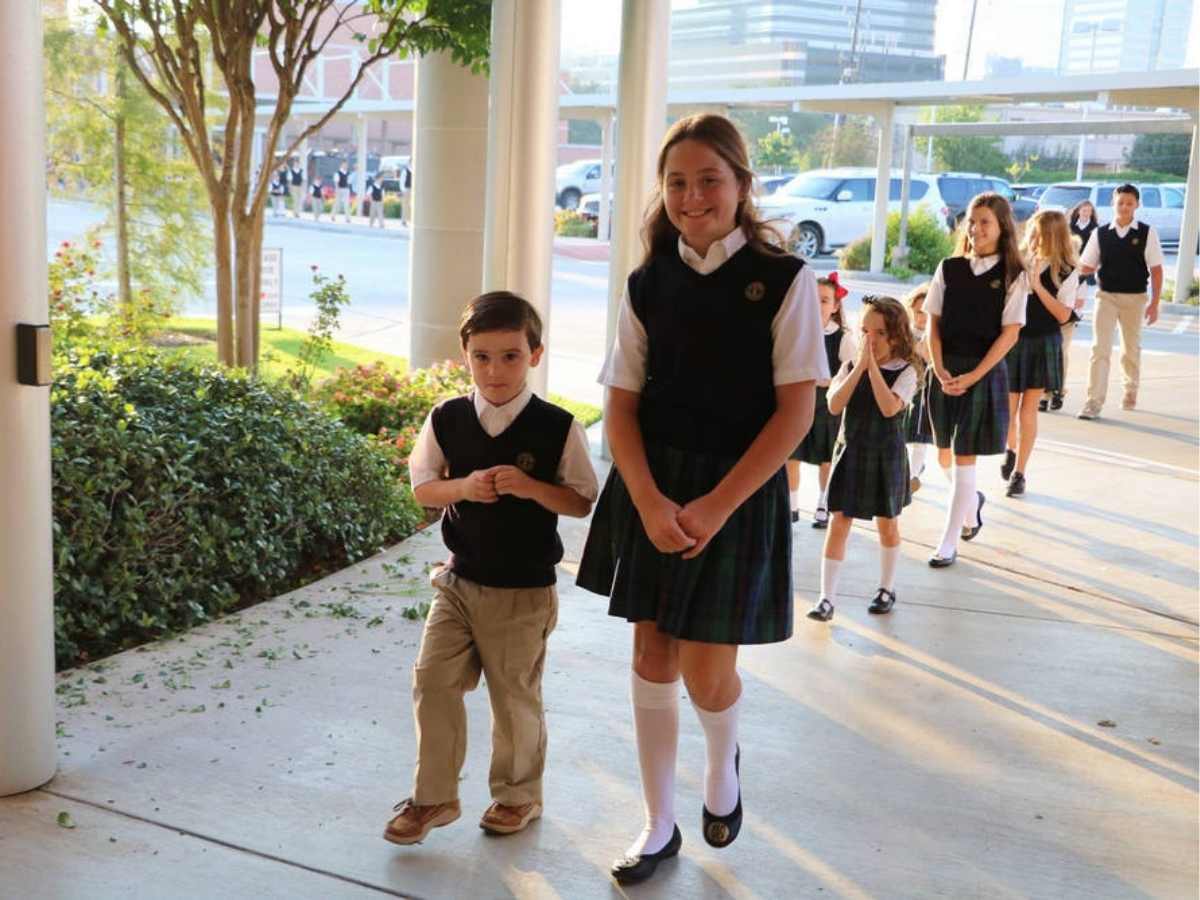Group of students in their school uniforms waling on sidewalk of school for article St Michael Catholic School