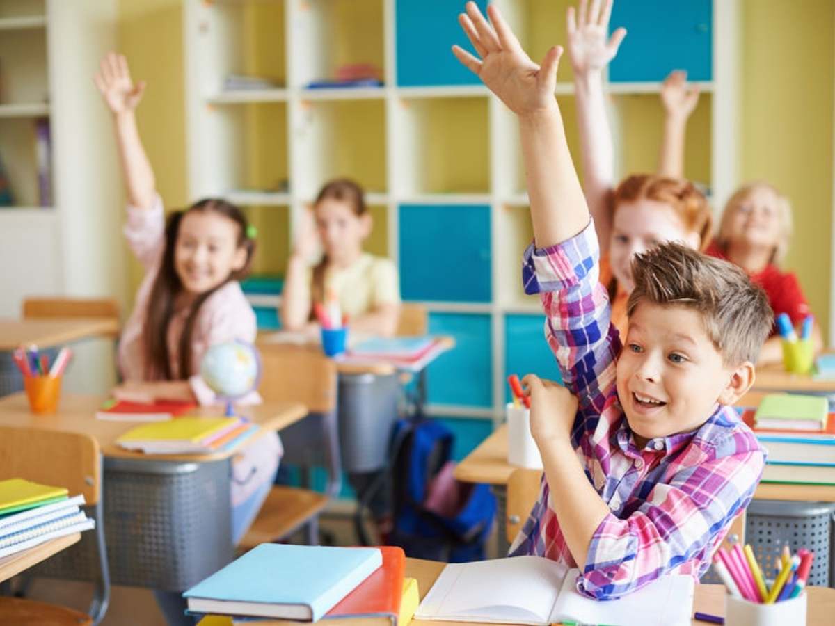 Kids raising hands in class for article Cypress Fairbanks Independent School District