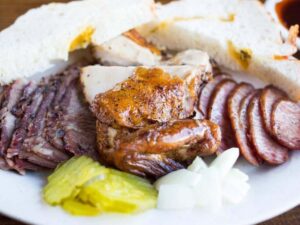 Sampler plate of BBQ meats for article Top Barbecue Restaurants in South Houston for newcomers moving to Houston.