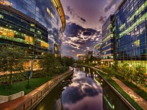 Canal running between buildings for article Living in The Woodlands, Texas for newcomers moving to Houston.