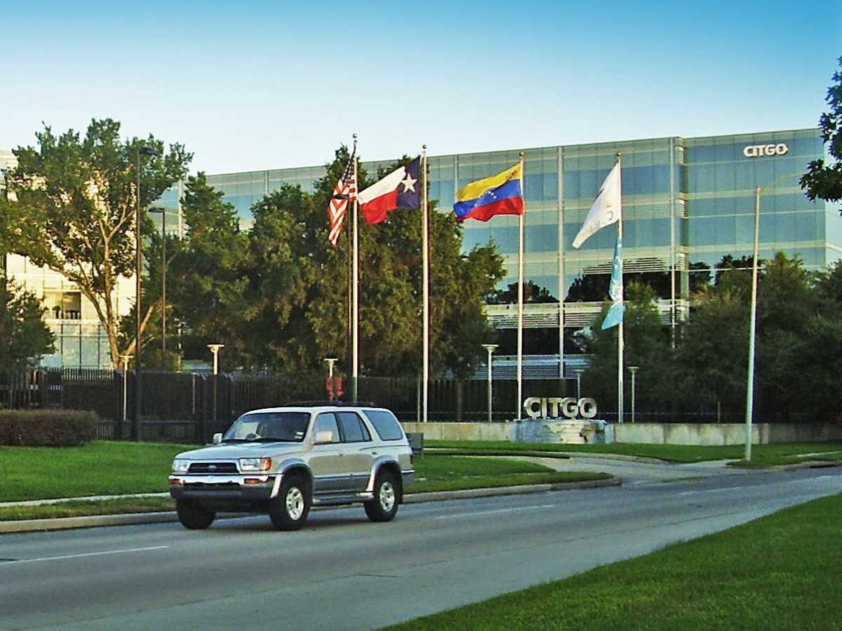 Citgo HQ in Houston showing building with flags and car driving by for article Largest Employers in The Energy Corridor of Houston for newcomers moving to Houston.