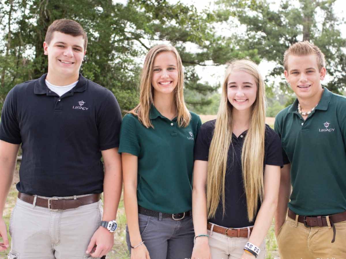 4 students posing for photo in Legacy Prep school uniforms for article Legacy Preparatory Christian Academy