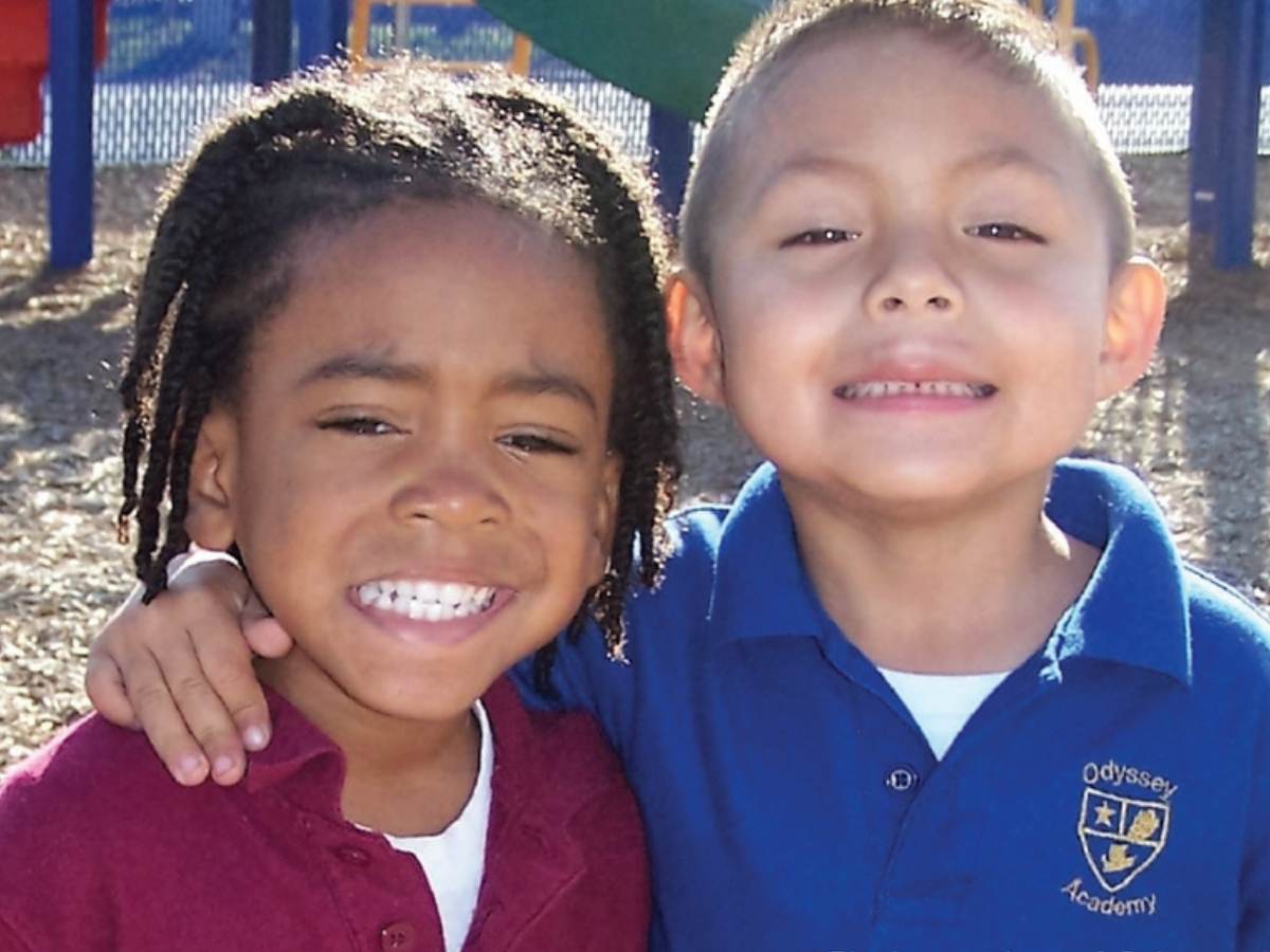 2 kids posting together smiling for the camera for article Odyssey Academy