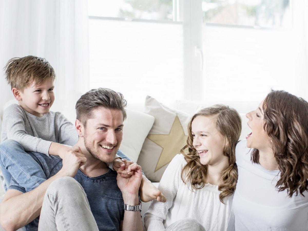 Young family of 4 in home for article SouthCoast Cooling, Heating & Indoor Air Quality