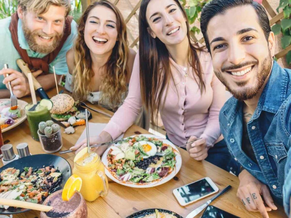Group of millennials eating out and posing for a picture together for article Why Millennials in Houston Thrive in 2025 for newcomers moving to Houston.