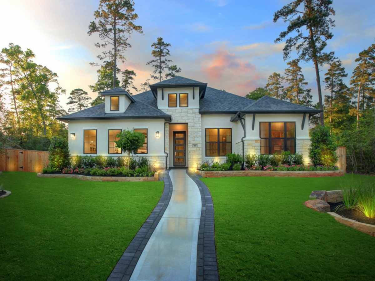 Large 2 story Drees home with long walkway going up to front door and perfectly landscaped yard with green grass and paver stones around landscaping for article Johnson Development Plans ‘Best of the Burbs’ Tour.