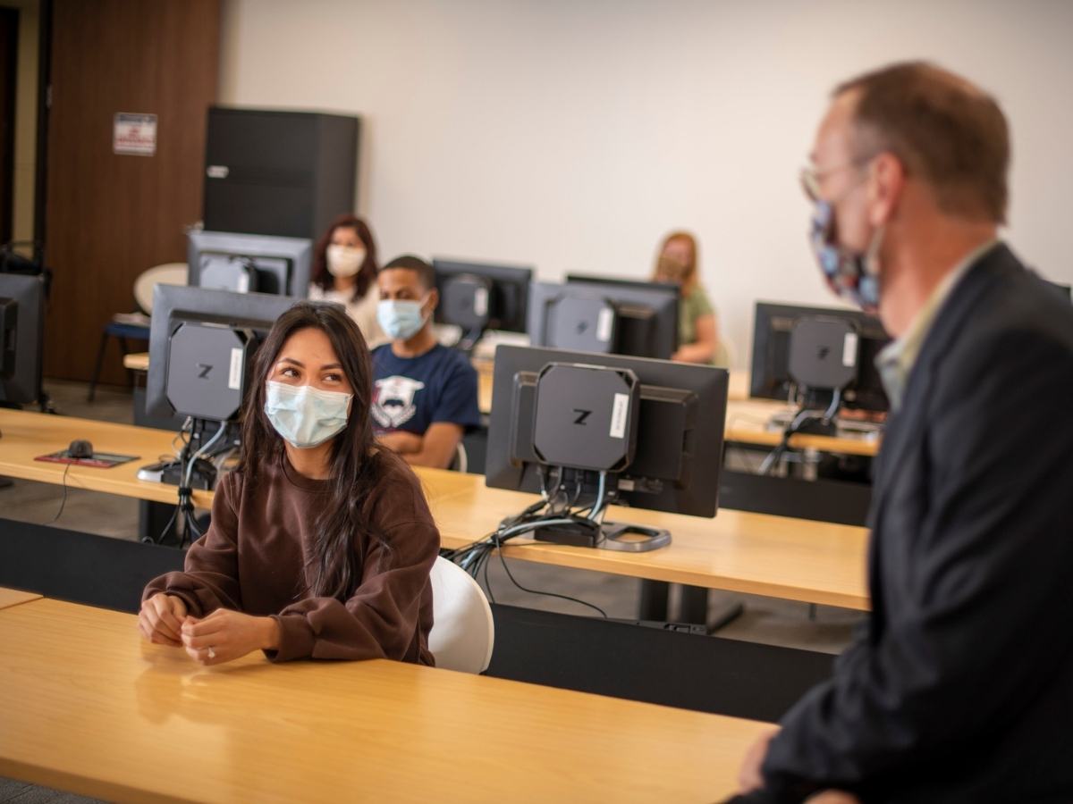 Teacher sitting in front right corner facing students spaced in classroom for article Houston's Lone Star College named 2021 Great Colleges to Work For®