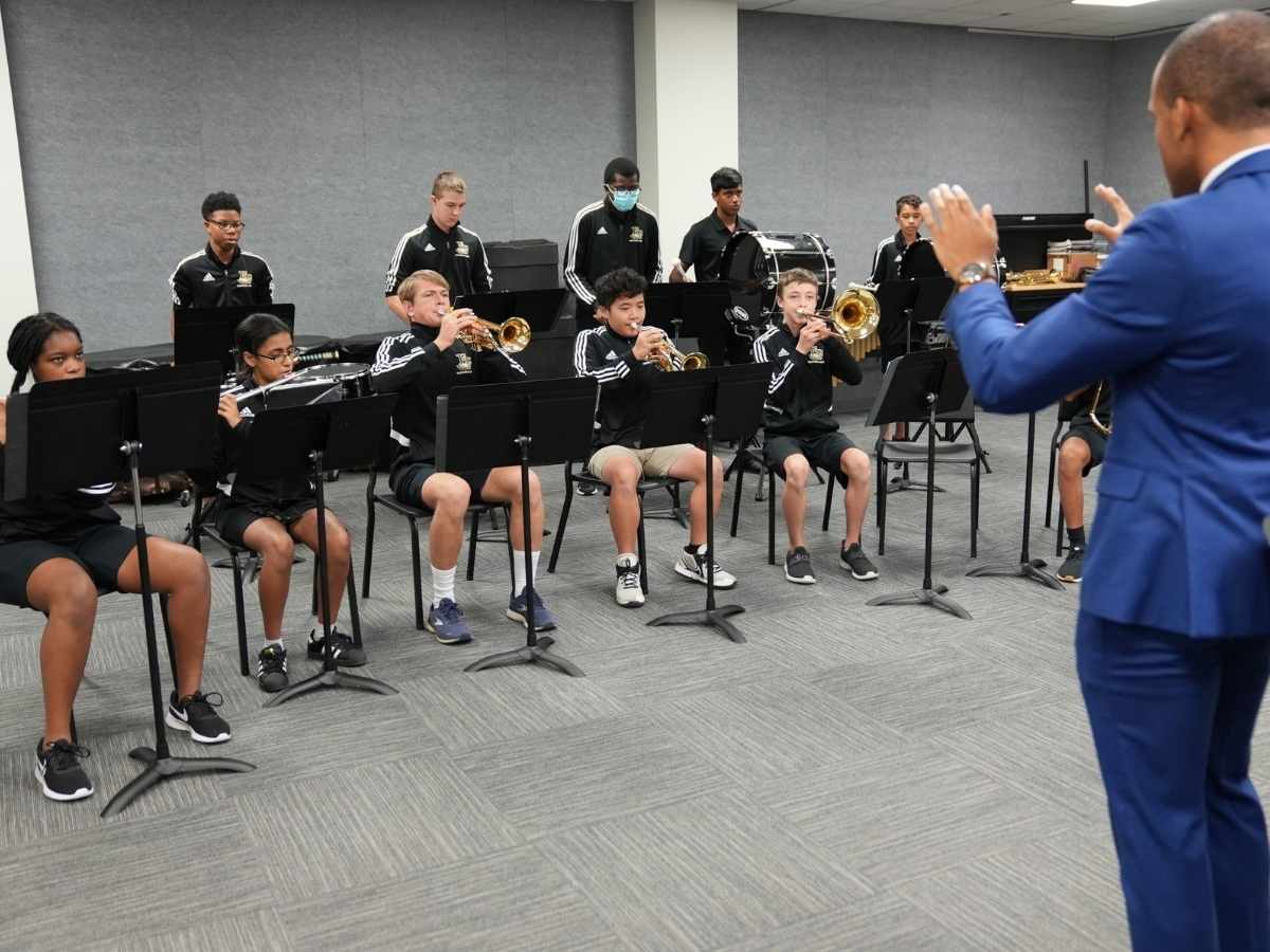 Band room with kids playing instruments for article Fort Bend Christian Academy Builds Band Room
