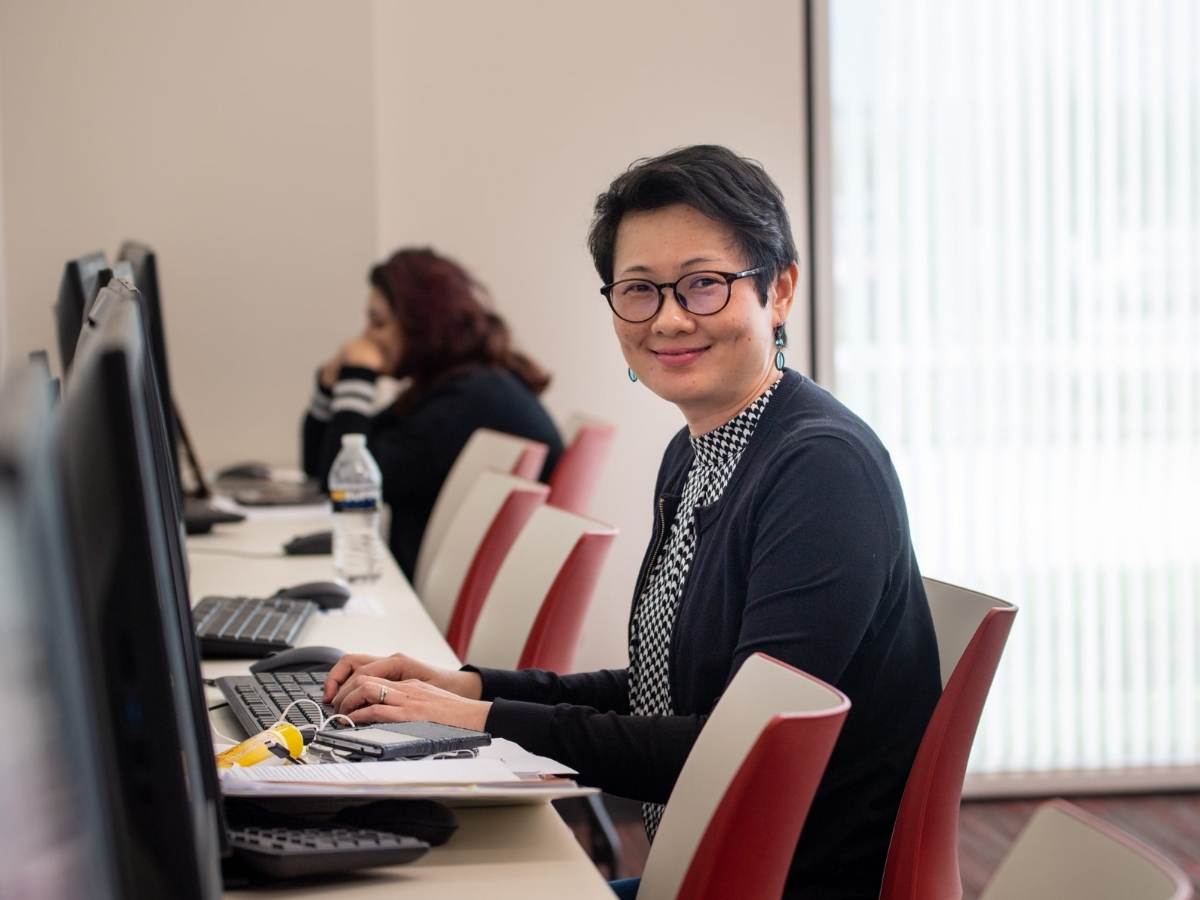 UHV Katy student sitting at computer for article University of Houston-Victoria