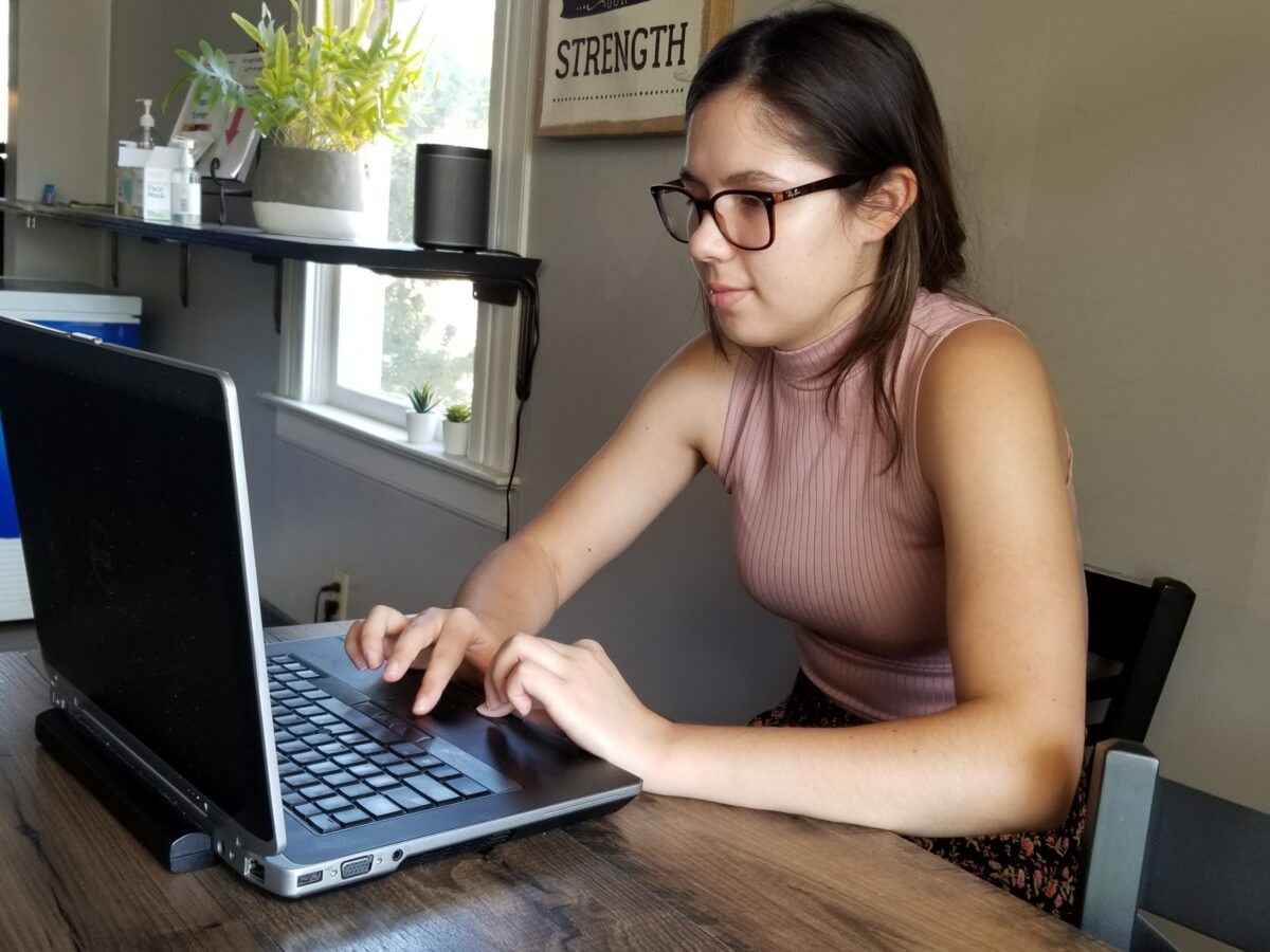 Girl working on laptop remotely from home for article