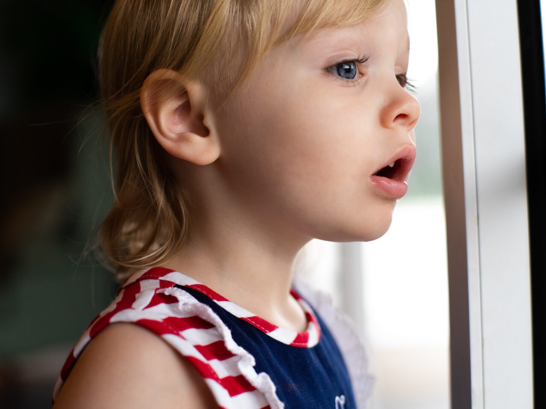 Child looking out of a window