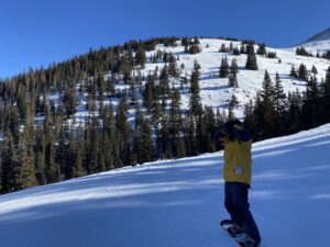 Snowboarder on a mountain for article Where Do Houstonians Go to Ski? for newcomers moving to Houston.