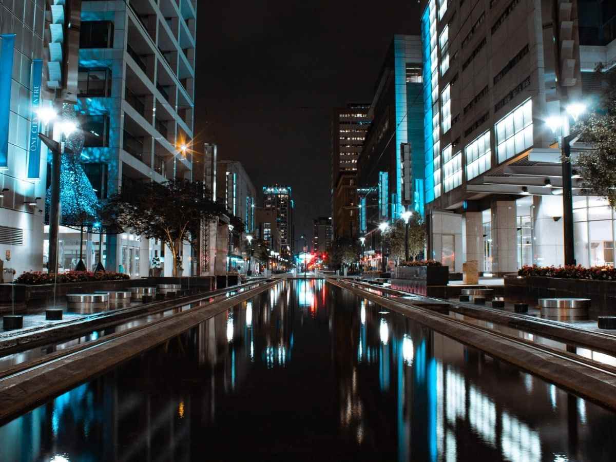 Downtown Houston at night showing canal running between office buildings for article Houstons Top Employers