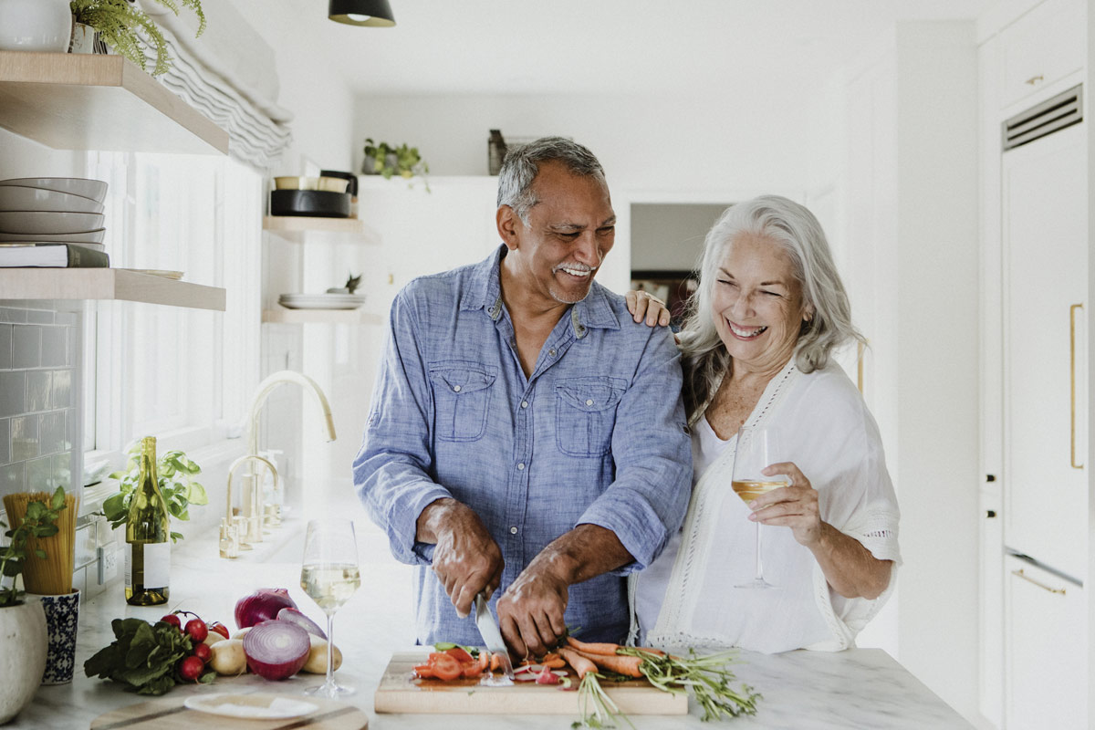 Department Image: RETIRE. Older couple cooking in their kitchen.