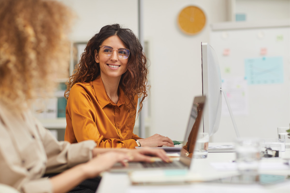 Department Image: WORK. Woman sitting infront of her desk in office