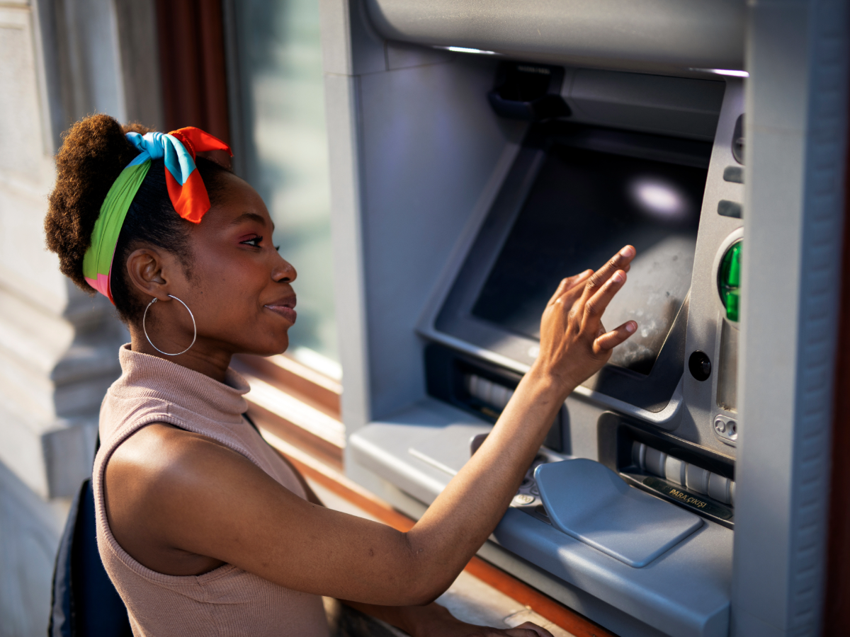 Woman using an ATM machine.