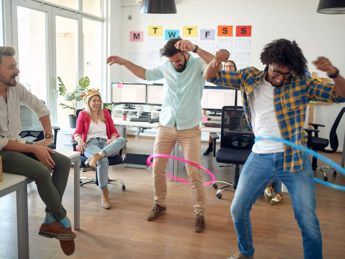 People having a hula hoop challenge in the office.