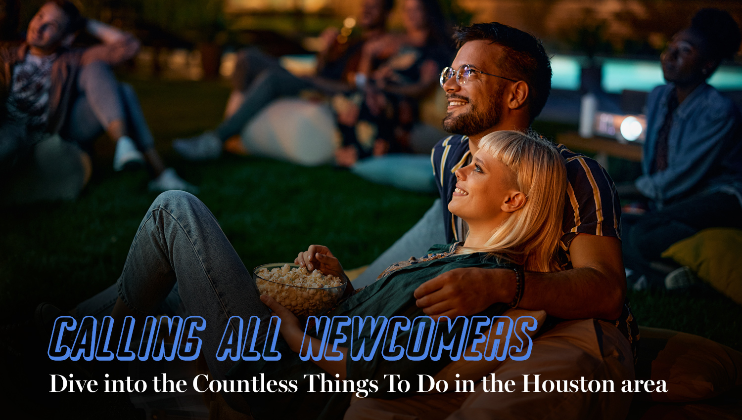 Calling all newcomers: Dive into the Countless Things To Do in the Houston area. Couple watching a movie outside, in a park in the evening. 