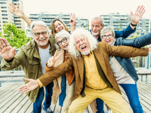 Group of 6 senior adults posing for camera outside.