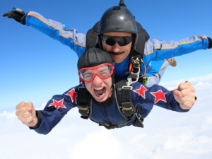 2 people tandem skydiving.