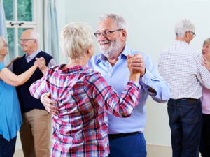 Senior adults learning to dance in a class.