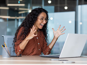 Person celebrating in front of computer after finding contract work online.