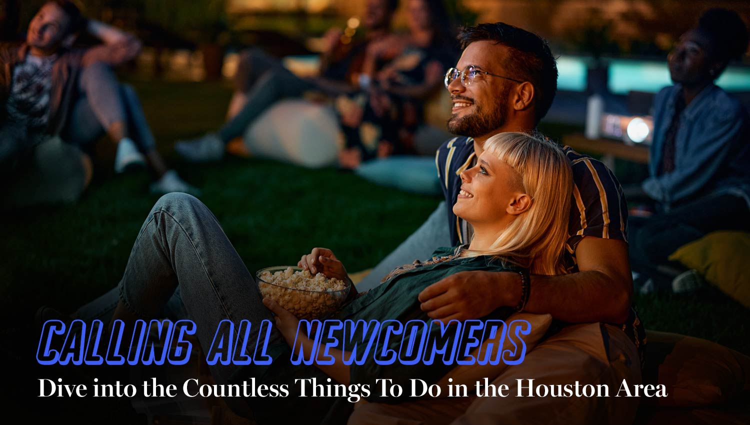 Calling all newcomers: Dive into the Countless Things To Do in the Houston area. Couple watching a movie outside, in a park in the evening.