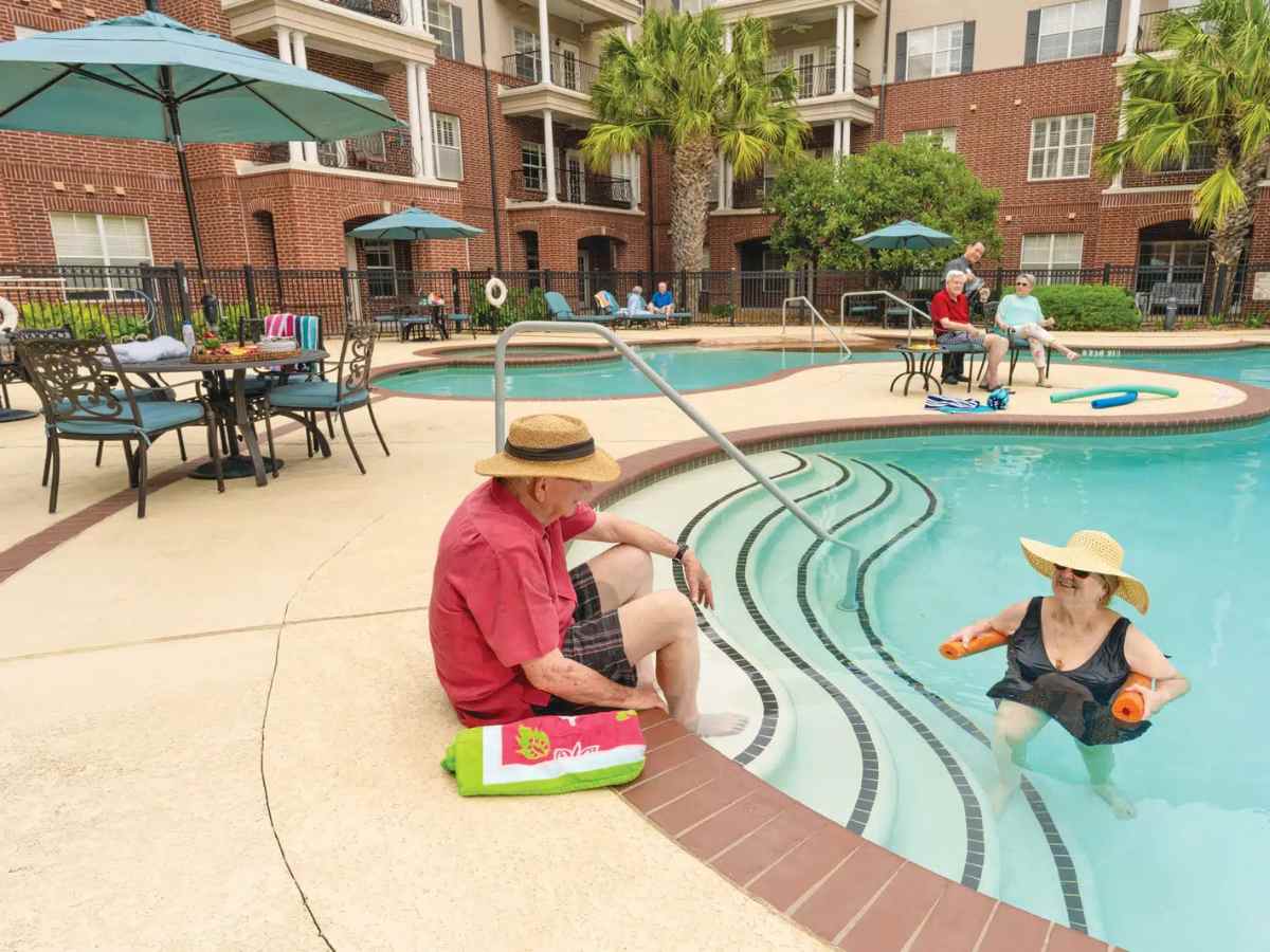 Retired seniors hanging out at the pool at The Buckingham for article 6 Diverse Housing Options for Seniors in Houston.