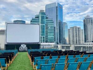 Rooftop cinema club showing screen and chairs on Houston Rooftop for article Unique Date Night in Houston for newcomers moving to Houston.