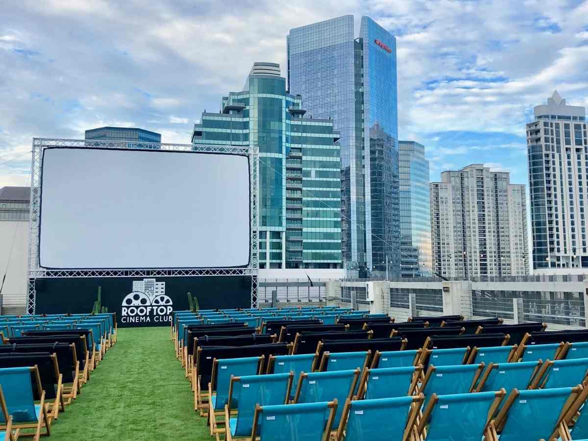 Rooftop cinema club showing screen and chairs on Houston Rooftop for article Unique Date Night in Houston for newcomers moving to Houston.