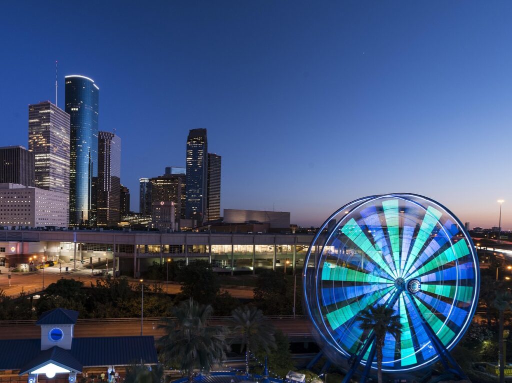 a ferris wheel in front of a city in Houston, Houston tenant rights